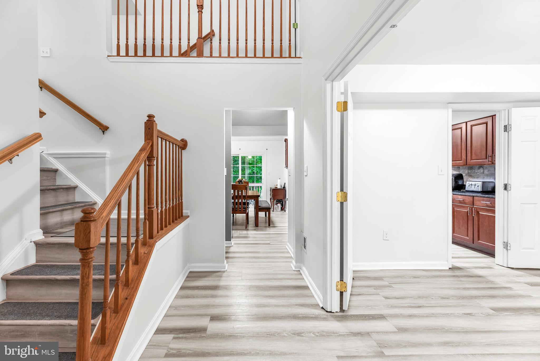8328 Ridge View Road Lusby, MD 20657 - Photo 5 of 34 a view of a hallway to a livingroom with wooden floor and stairs