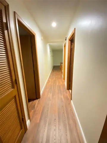 a view of hallway with wooden floor