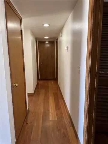 a view of balcony and hall with wooden floor