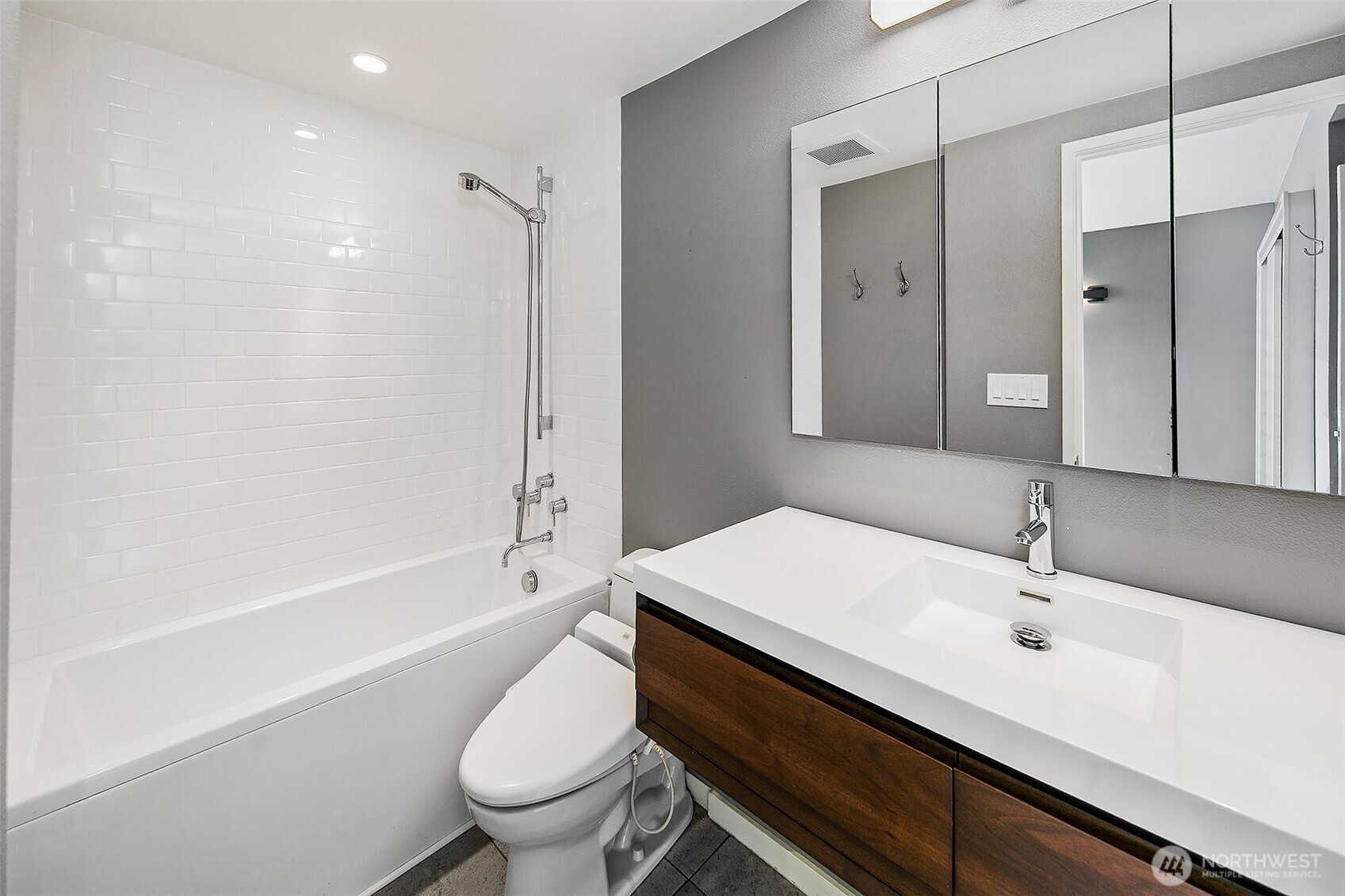 1101 Seneca Street, Unit 1301 Seattle, WA 98101 - Photo 15 of 40 a bathroom with a sink a toilet and shower