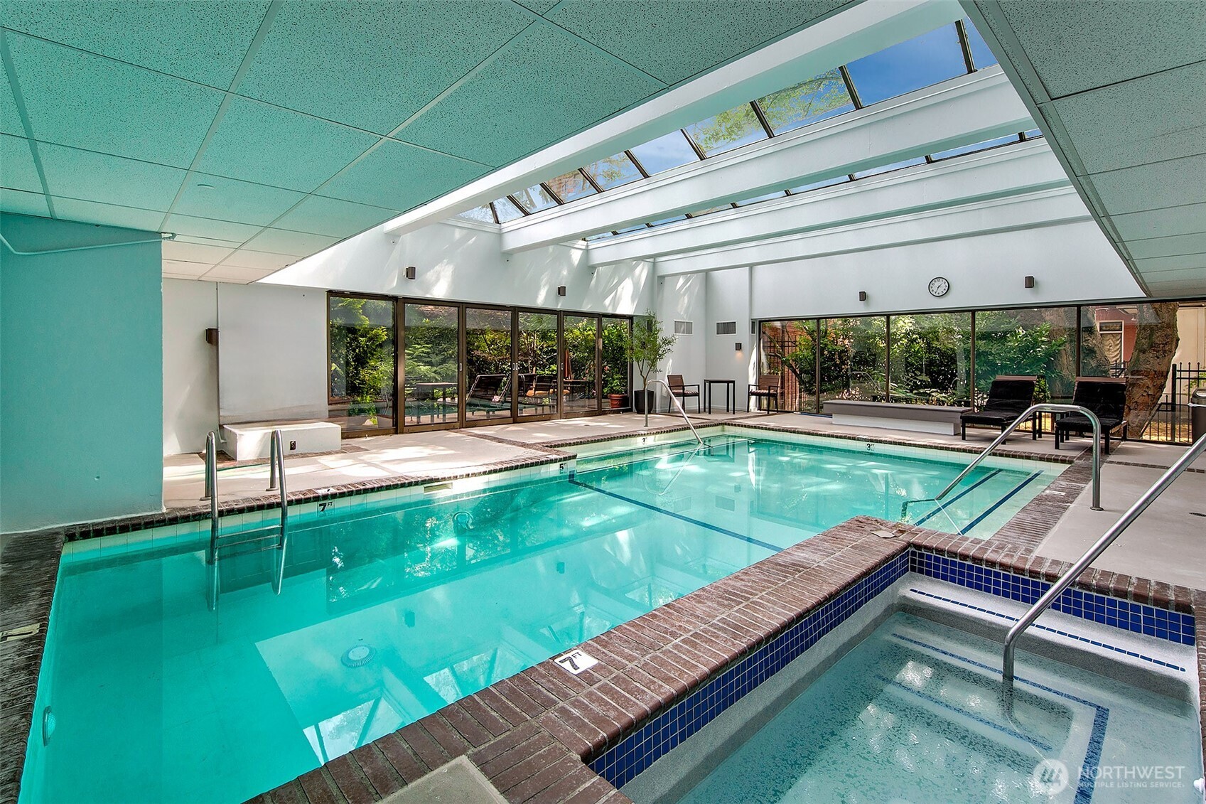 1101 Seneca Street, Unit 1301 Seattle, WA 98101 - Photo 28 of 40 a view of a patio with table and chairs with wooden floor and fence