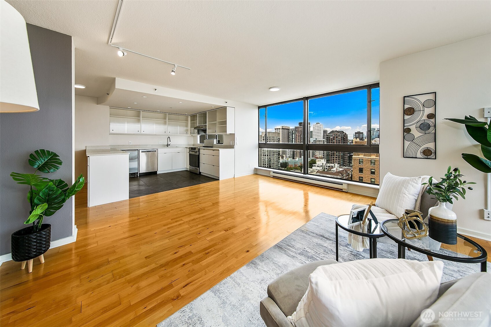 1101 Seneca Street, Unit 1301 Seattle, WA 98101 - Photo 5 of 40 a living room with furniture and a kitchen view