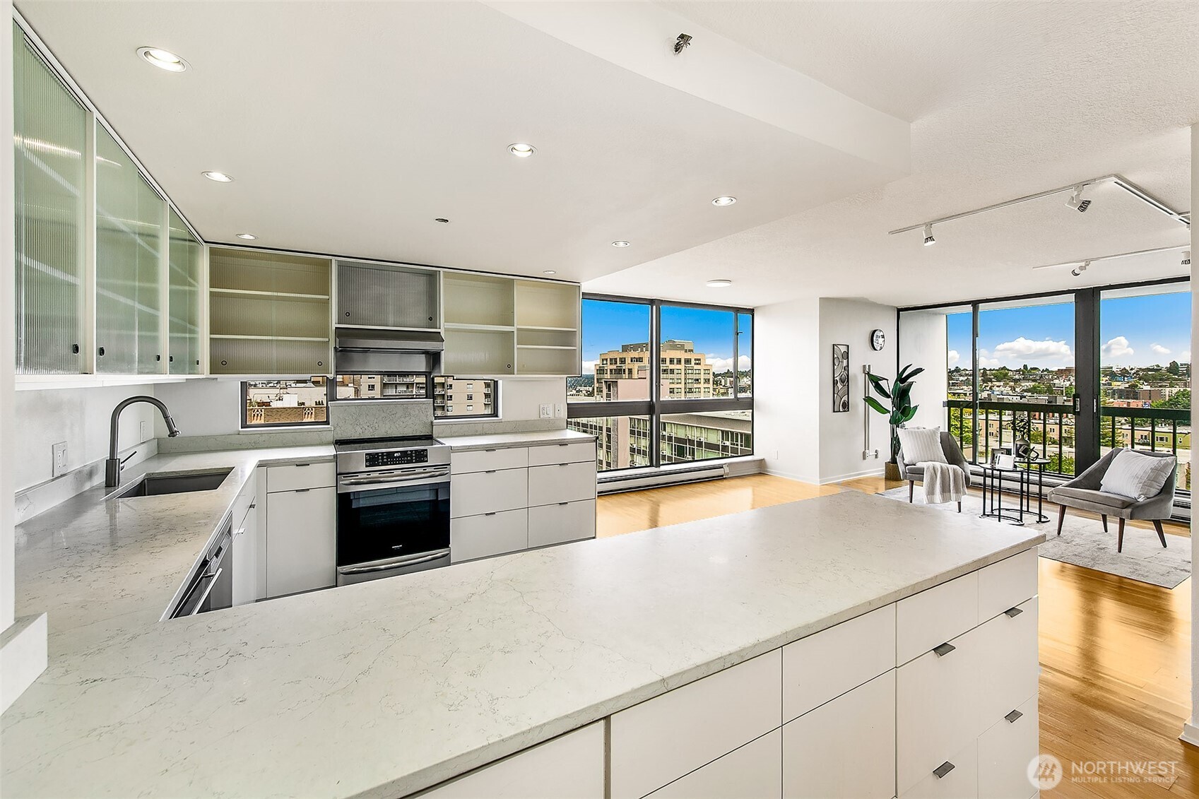 1101 Seneca Street, Unit 1301 Seattle, WA 98101 - Photo 10 of 40 a kitchen with stainless steel appliances granite countertop a sink a stove and cabinets