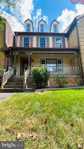 a front view of a residential apartment building with a yard