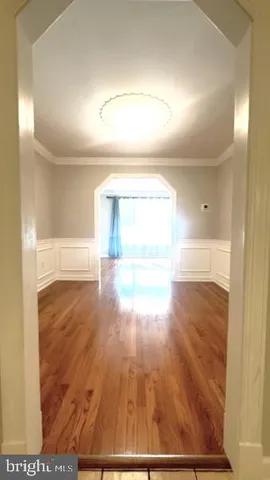 a view of an empty room and wooden floor
