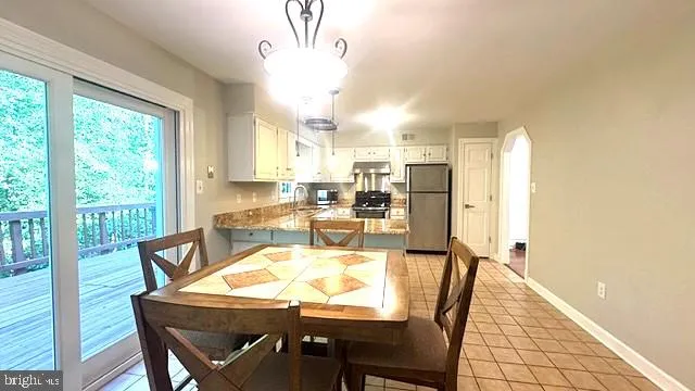 a view of a big room with wooden floor and windows