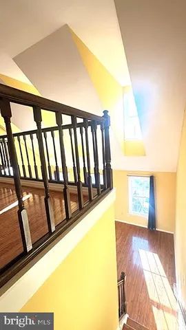 a view of a hallway with wooden floor and a fireplace