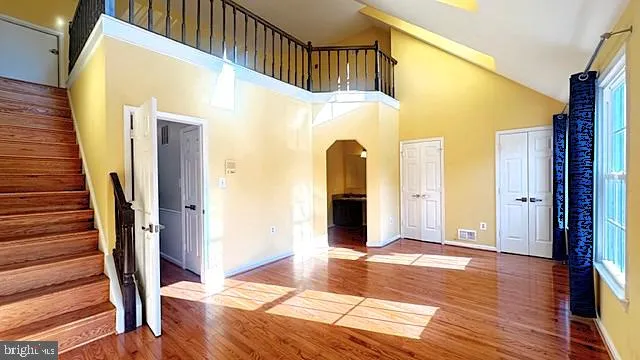 a kitchen with a dining table chairs and refrigerator