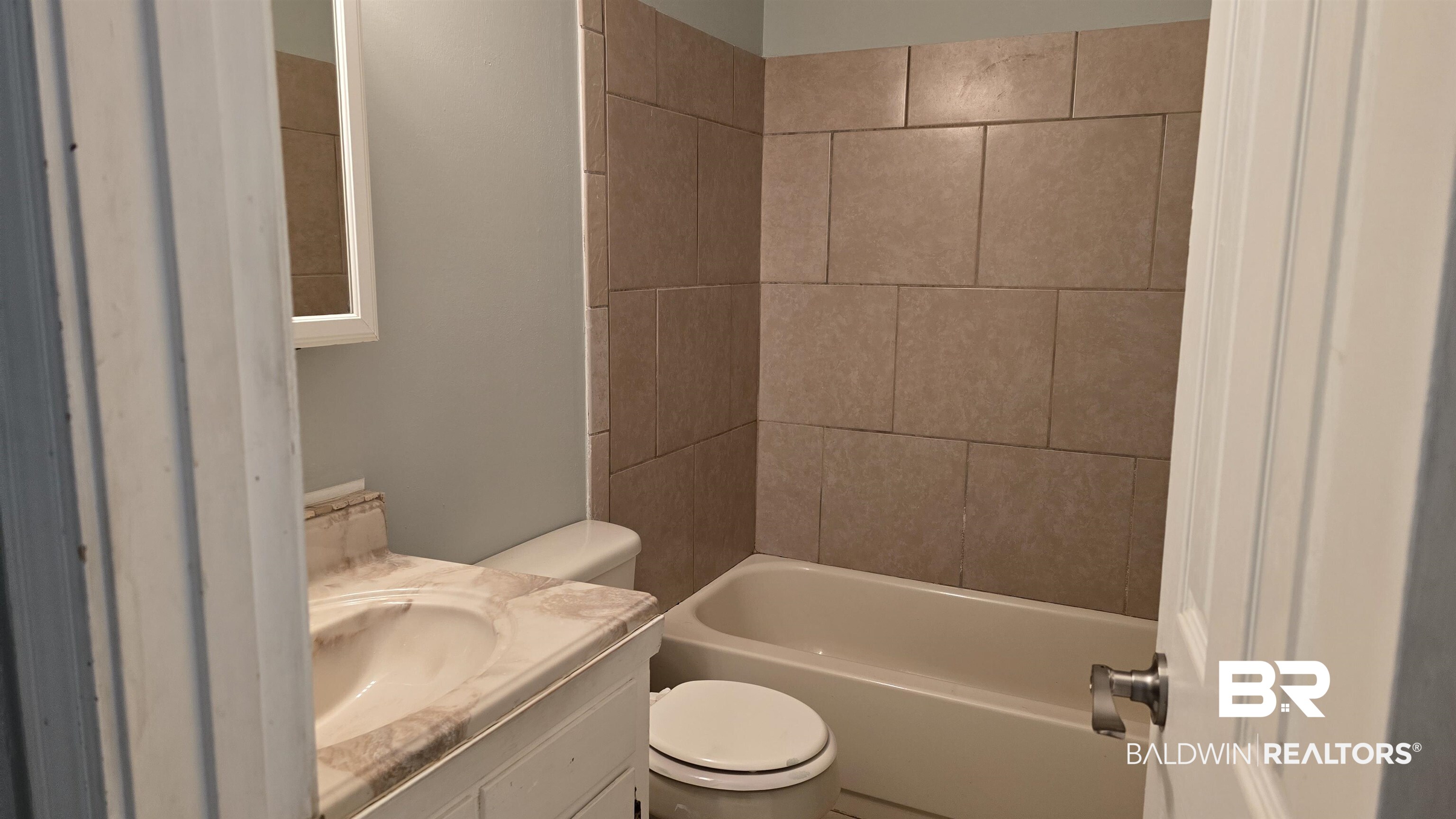 615 East Pedigo Avenue Foley, AL 36535 - Photo 24 of 31 Full bathroom featuring vanity and washtub / shower combination