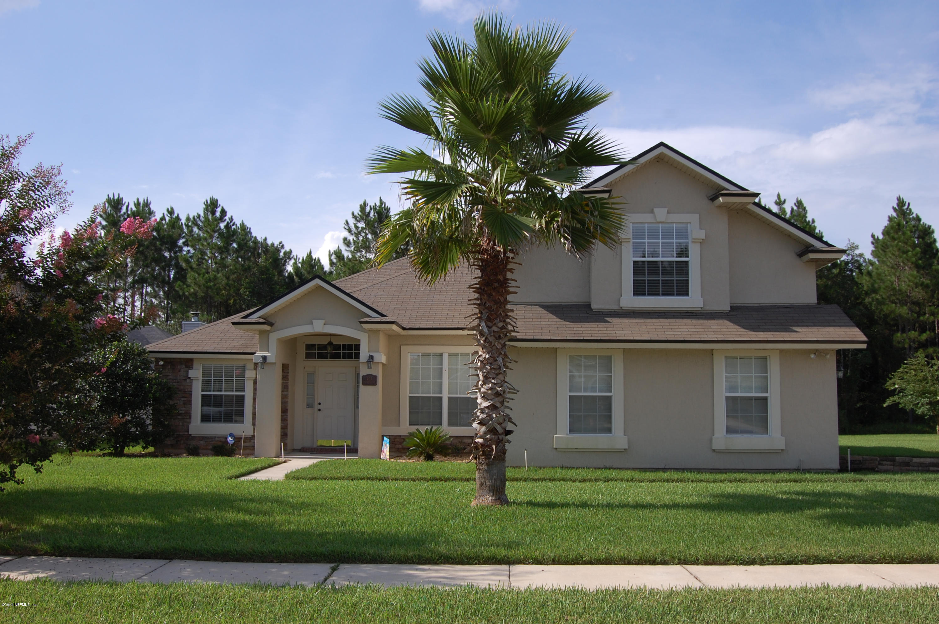404 Spring Ridge Court St. Augustine, FL 32092 - Photo 1 of 31 a front view of a house with a yard and garage