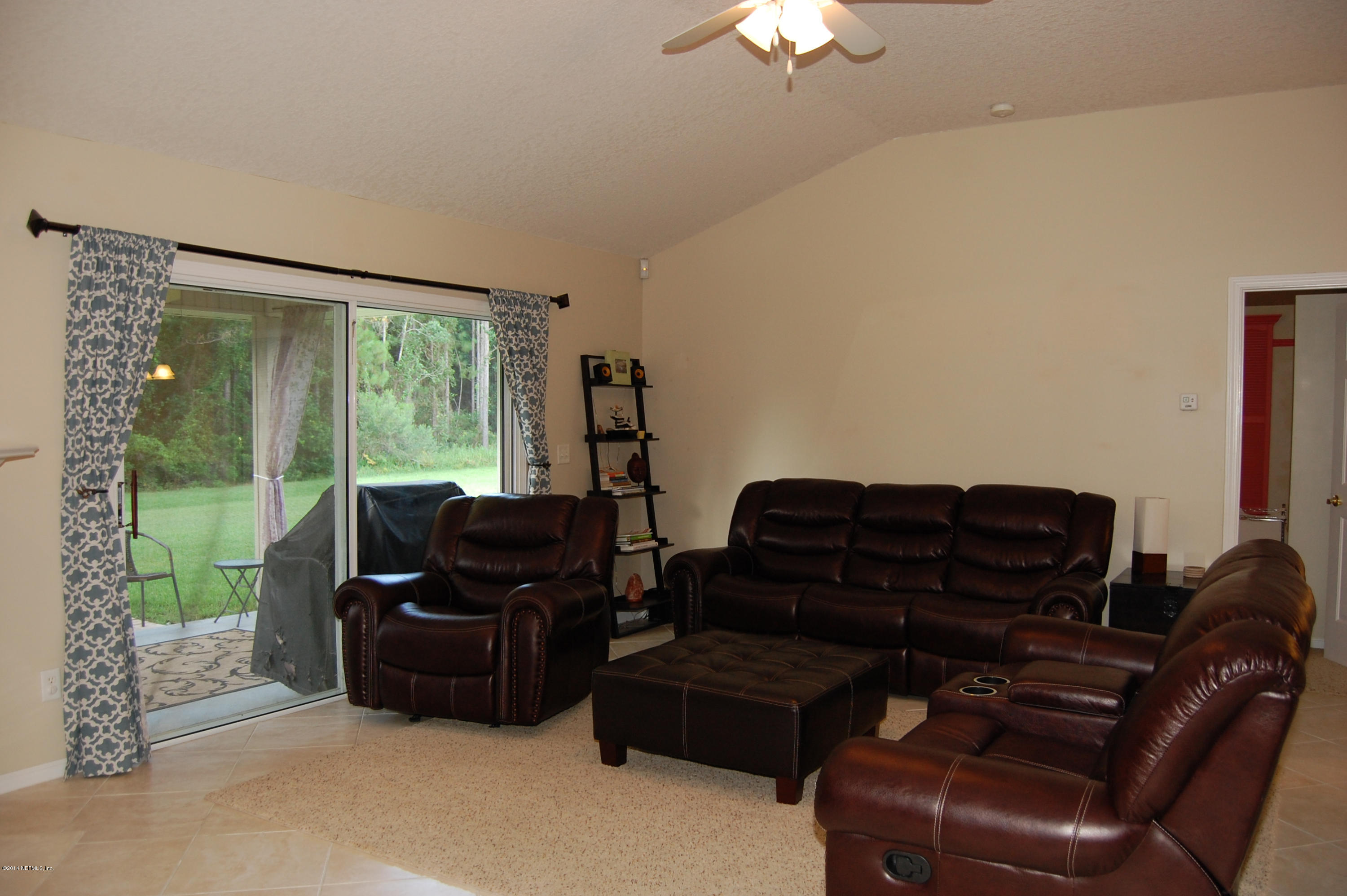 404 Spring Ridge Court St. Augustine, FL 32092 - Photo 14 of 31 a living room with furniture and a flat screen tv