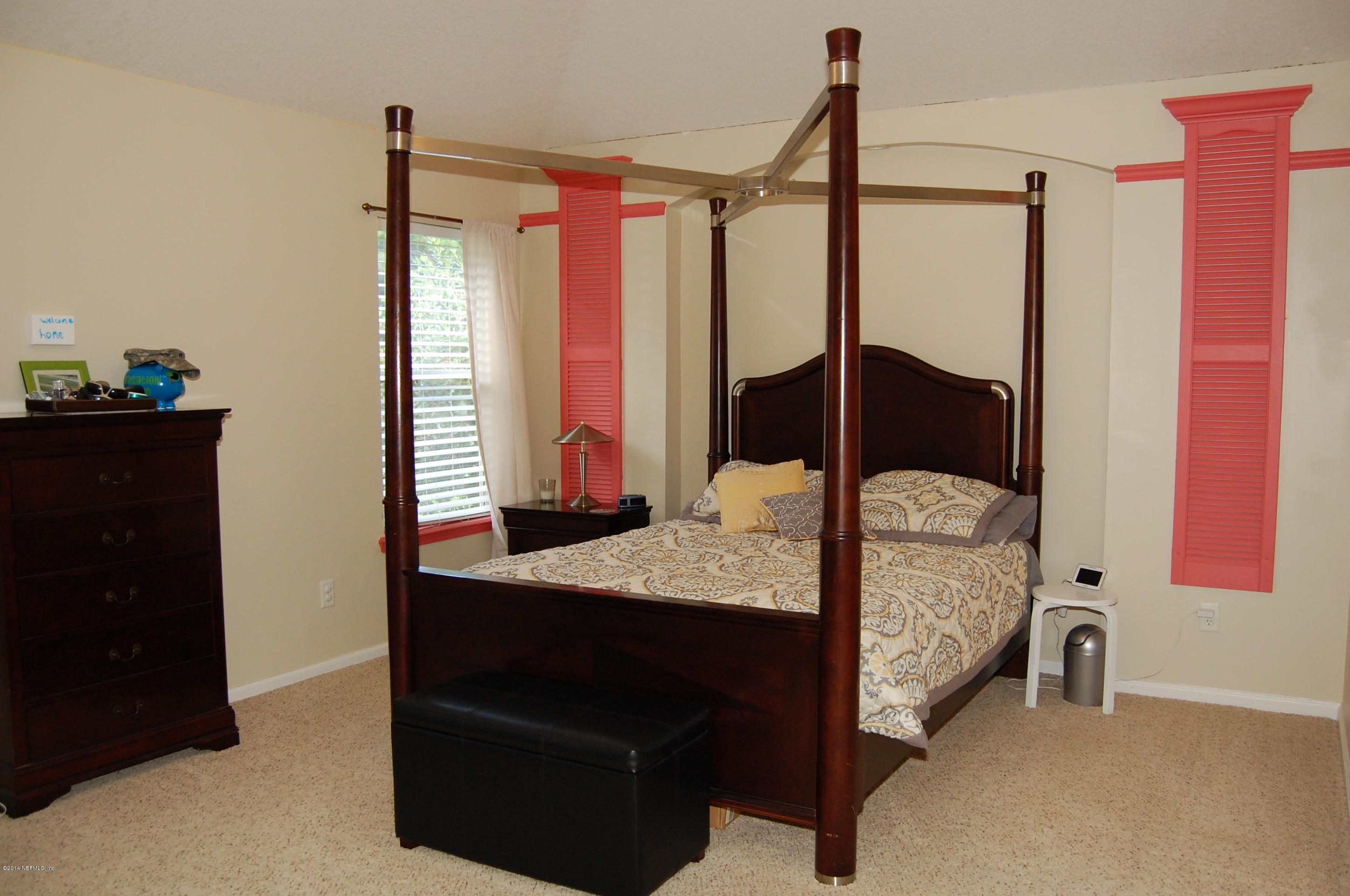 404 Spring Ridge Court St. Augustine, FL 32092 - Photo 19 of 31 a bedroom with a bed and a dresser