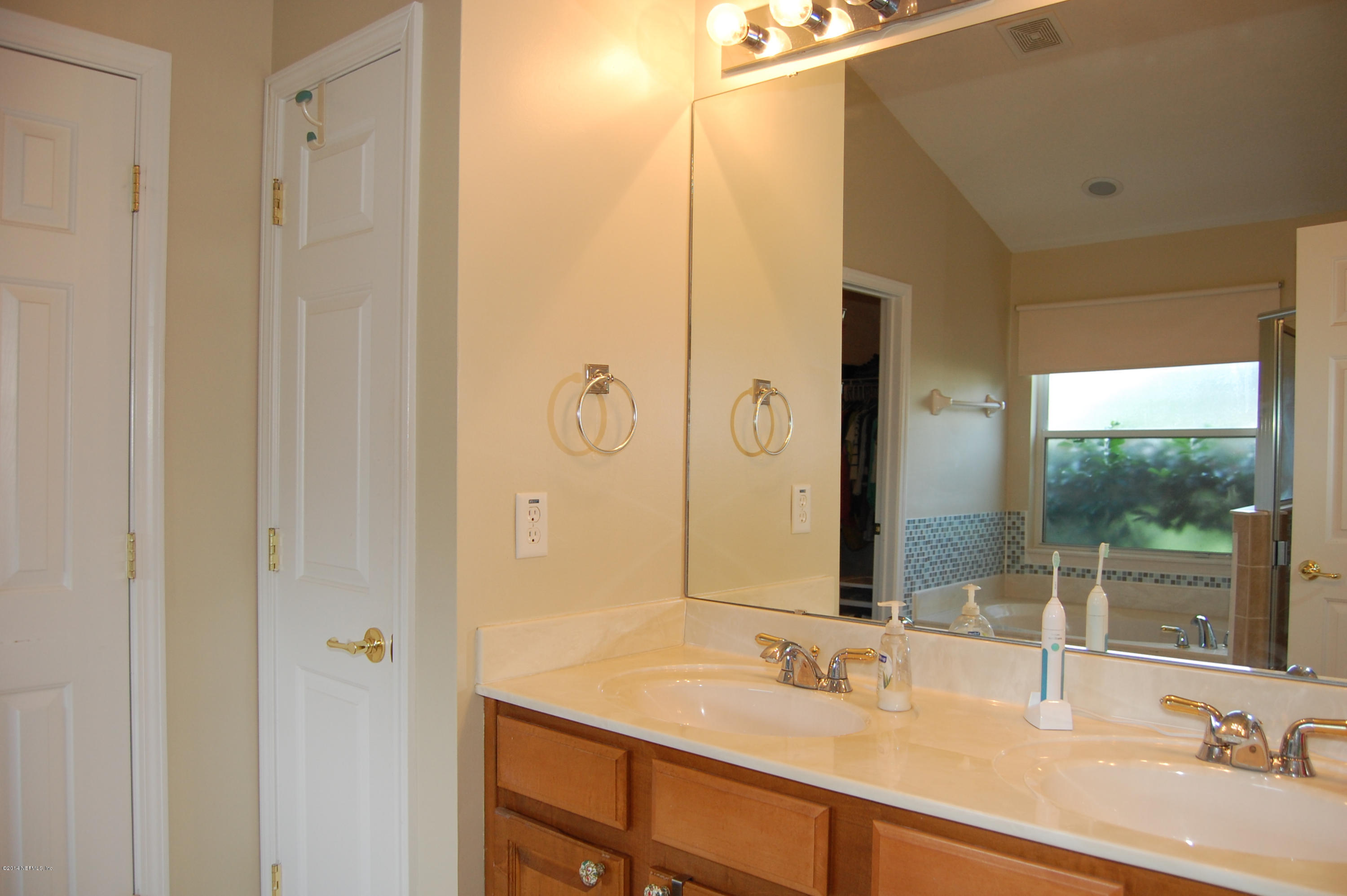 404 Spring Ridge Court St. Augustine, FL 32092 - Photo 20 of 31 a bathroom with a double vanity sink mirror and double