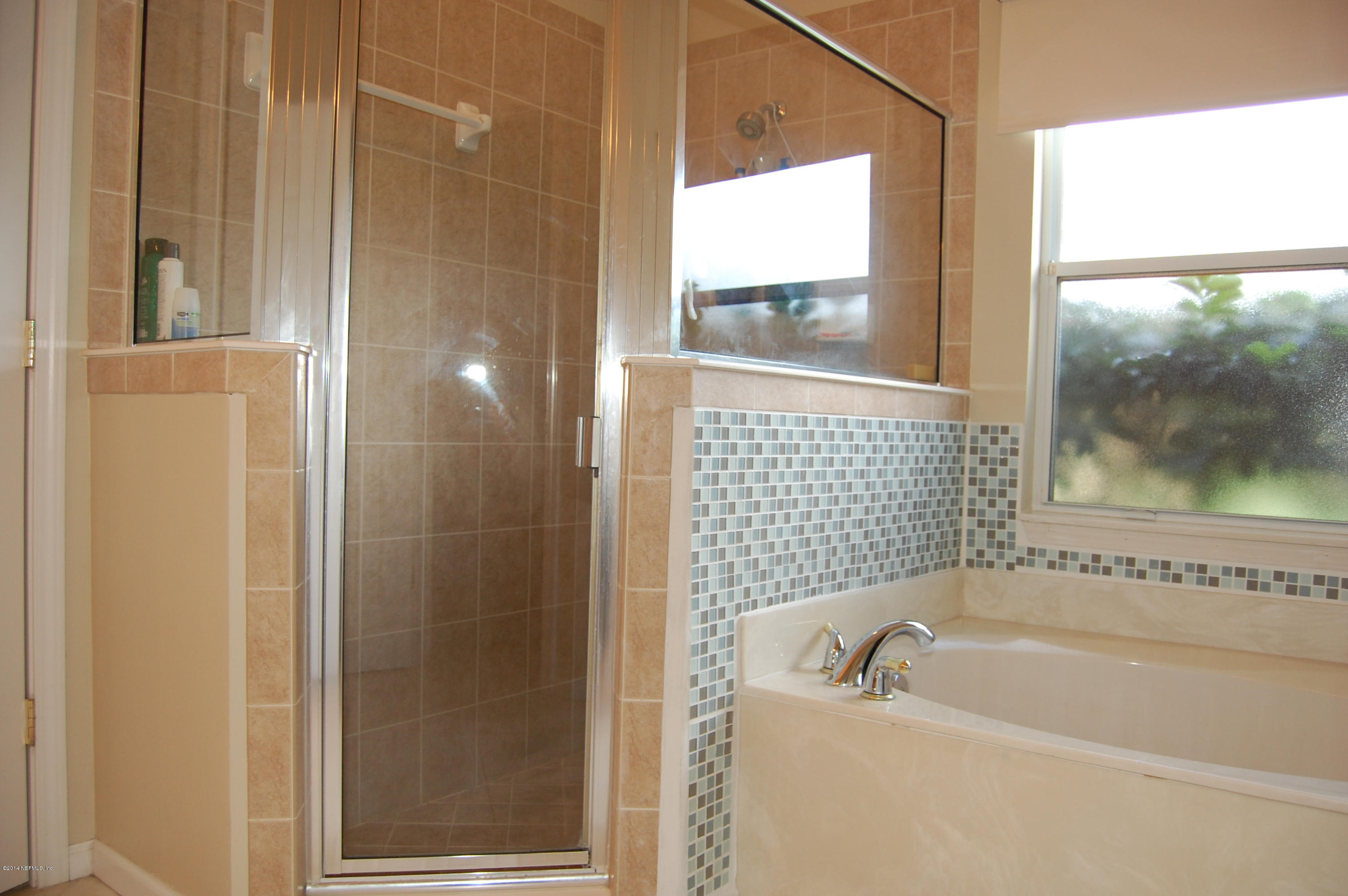 404 Spring Ridge Court St. Augustine, FL 32092 - Photo 21 of 31 a bathroom with a bathtub and a shower