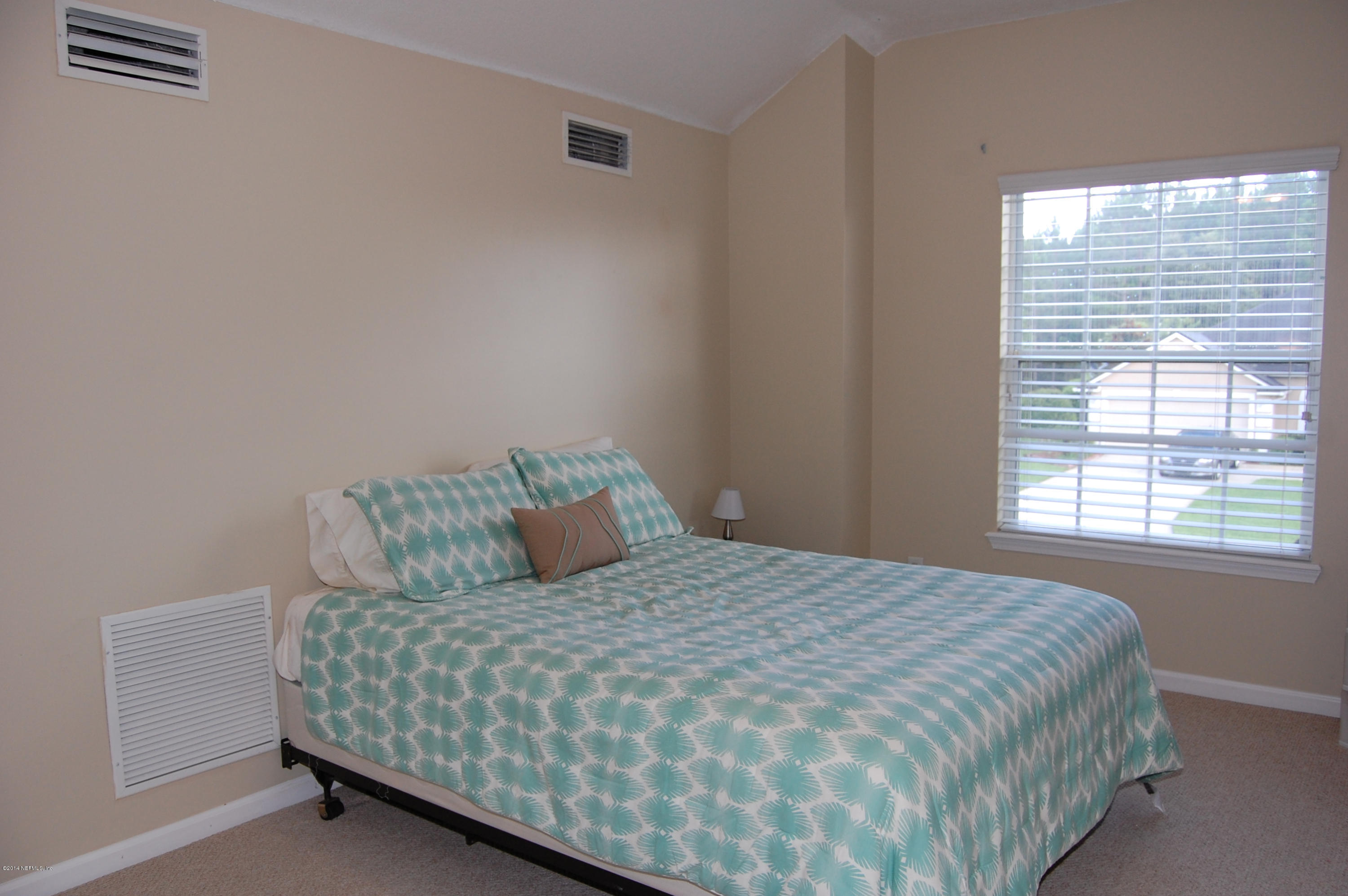 404 Spring Ridge Court St. Augustine, FL 32092 - Photo 23 of 31 a bedroom with a bed and window