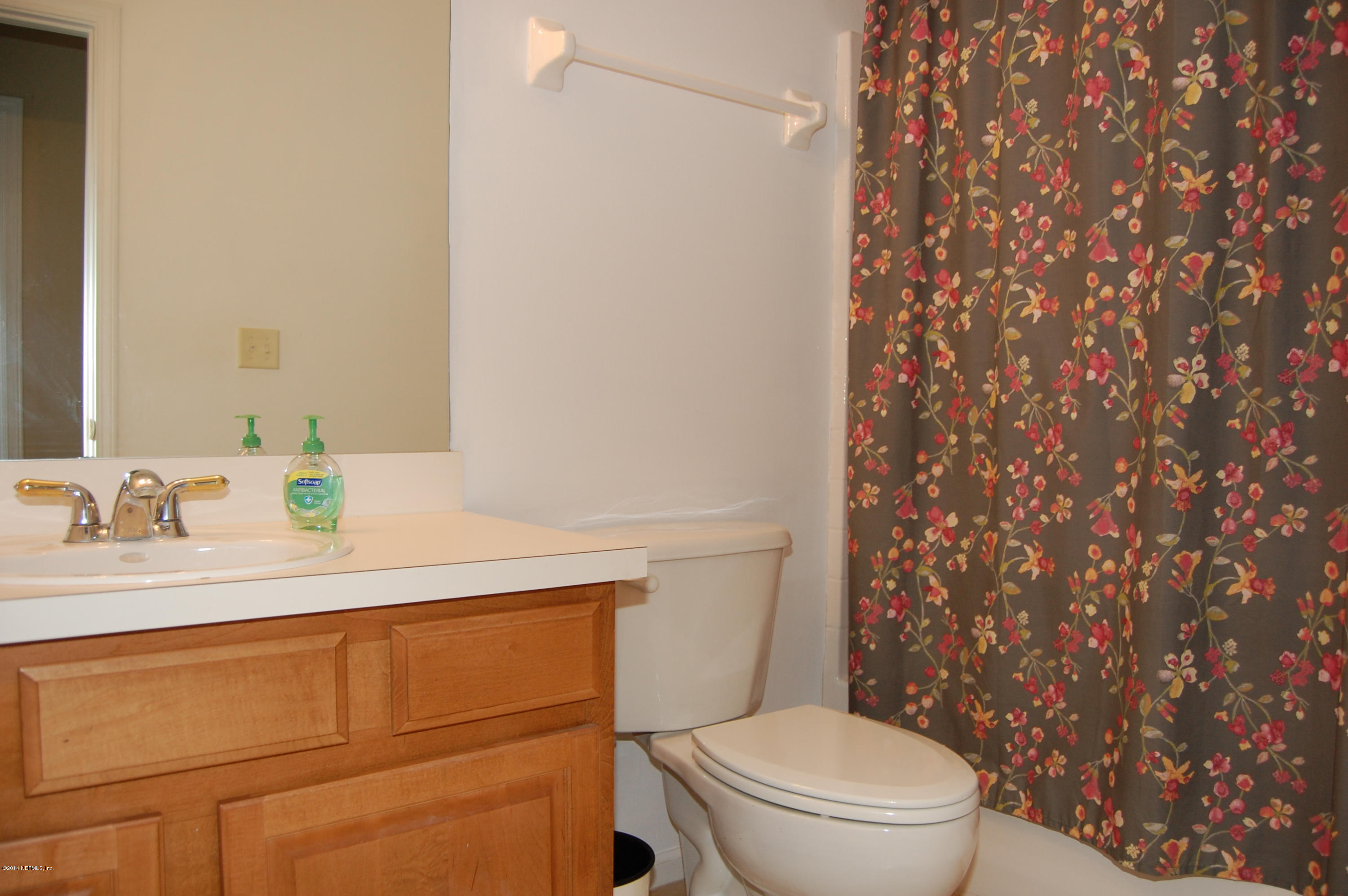 404 Spring Ridge Court St. Augustine, FL 32092 - Photo 24 of 31 a bathroom with a sink a toilet and a mirror