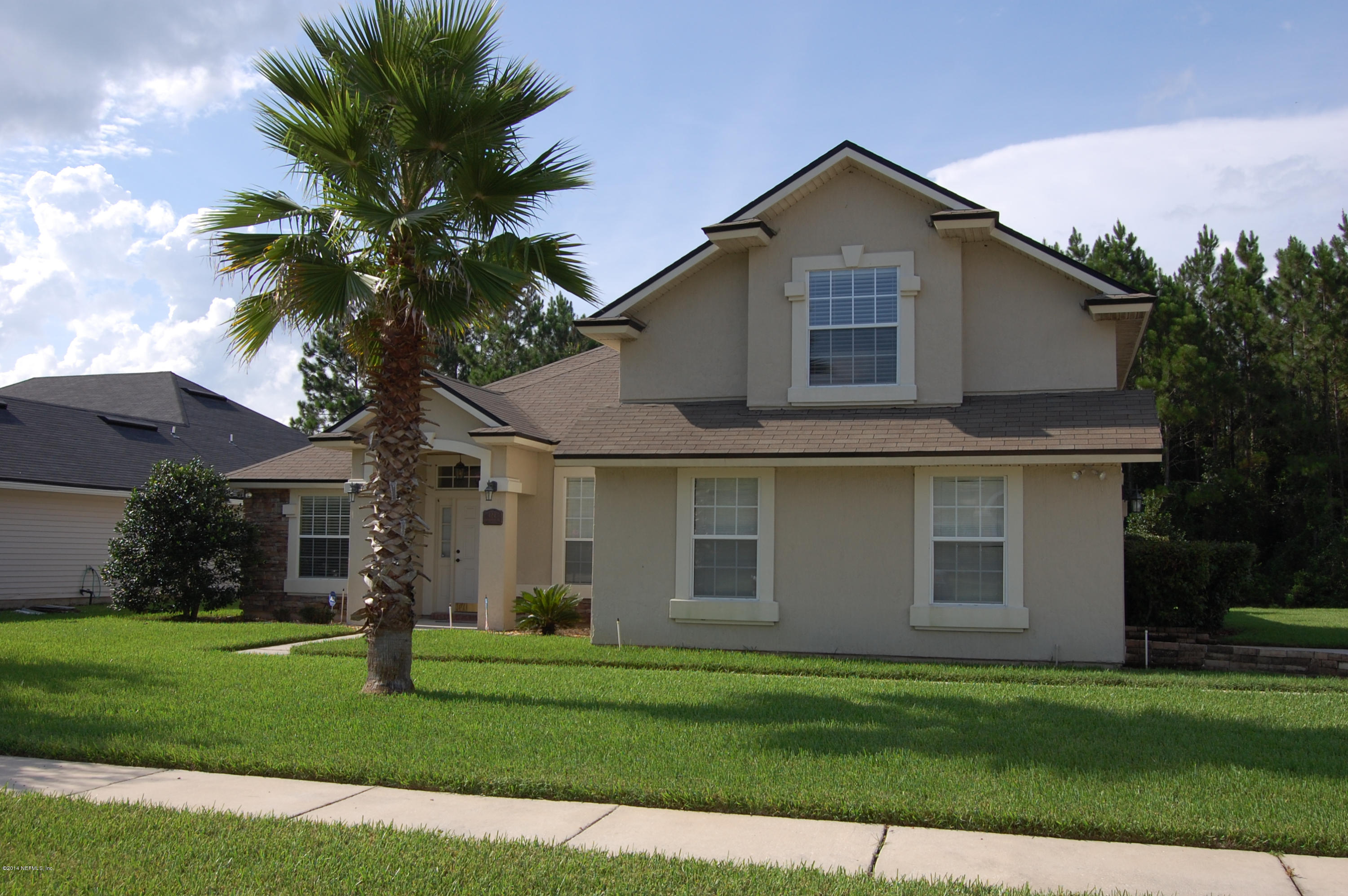 404 Spring Ridge Court St. Augustine, FL 32092 - Photo 3 of 31 a front view of a house with a yard and garage