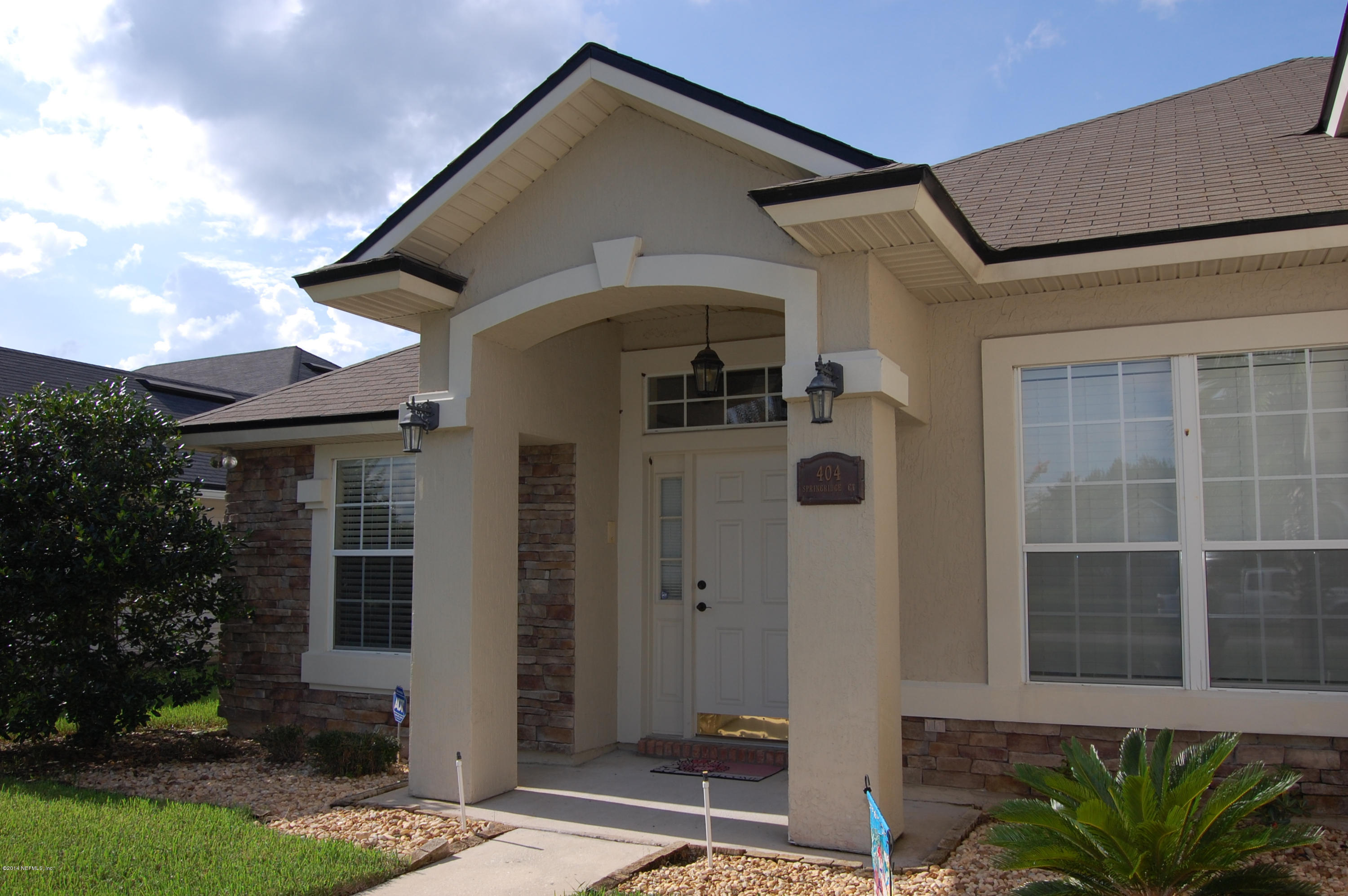 404 Spring Ridge Court St. Augustine, FL 32092 - Photo 4 of 31 a front view of a house with a yard