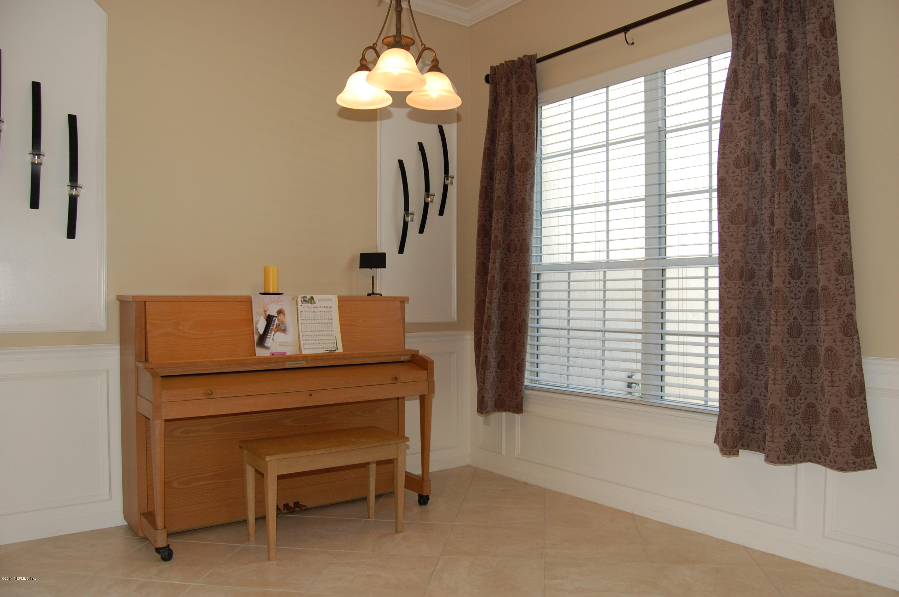 404 Spring Ridge Court St. Augustine, FL 32092 - Photo 5 of 31 a view of a room with a hanging floor to ceiling window and a chandelier