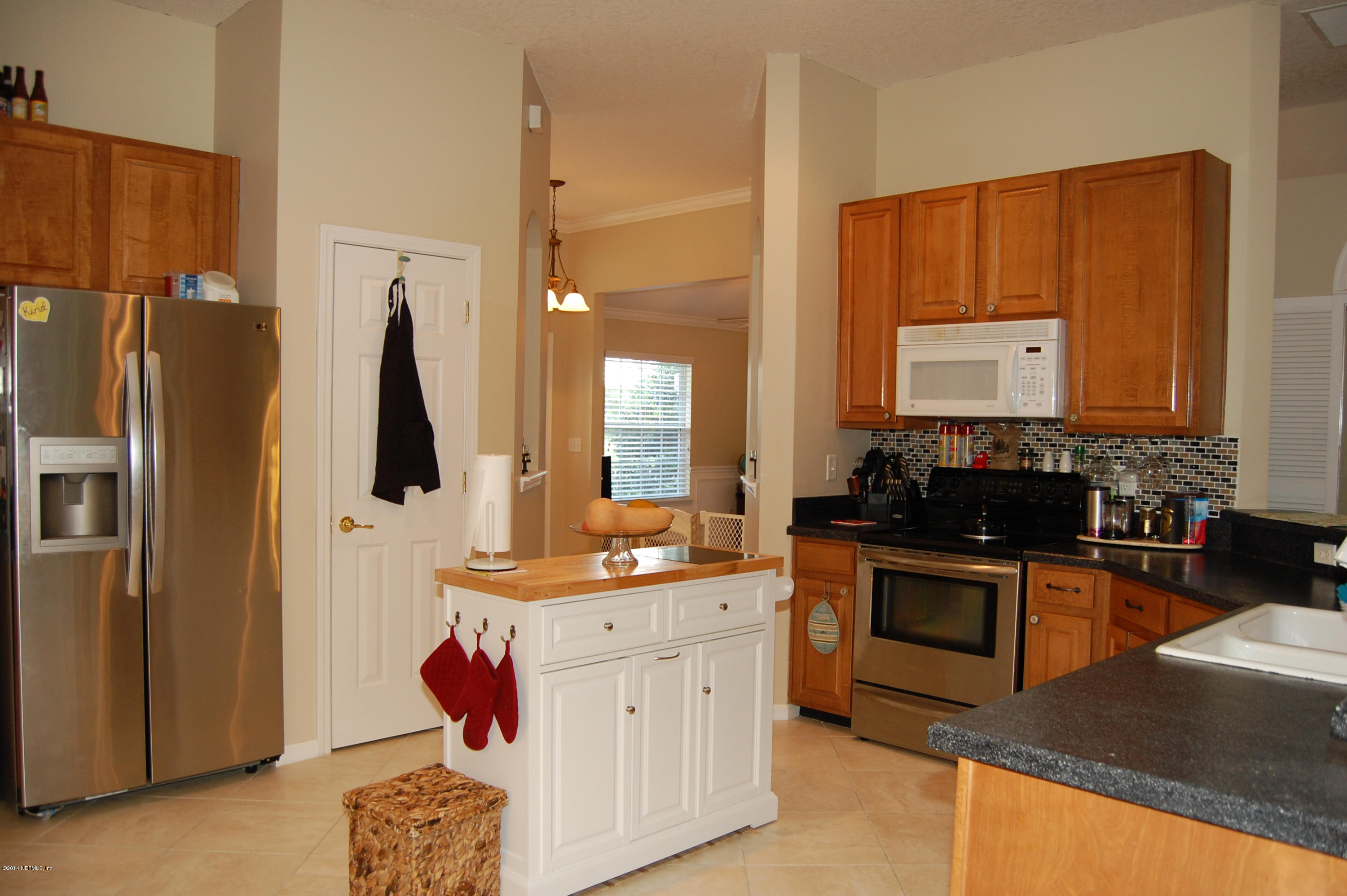 404 Spring Ridge Court St. Augustine, FL 32092 - Photo 9 of 31 a kitchen with a sink stove and refrigerator