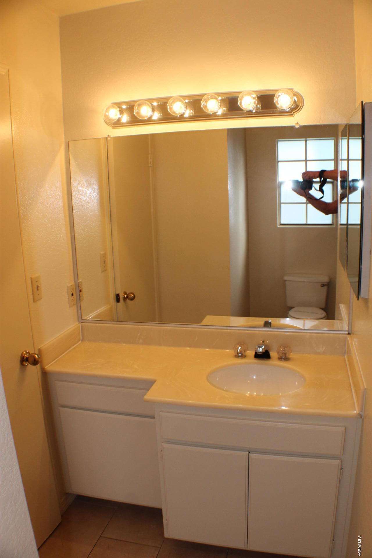 1878 Rory Lane, Unit 2 Simi Valley, CA 93063 - Photo 28 of 30 a bathroom with a sink and a mirror