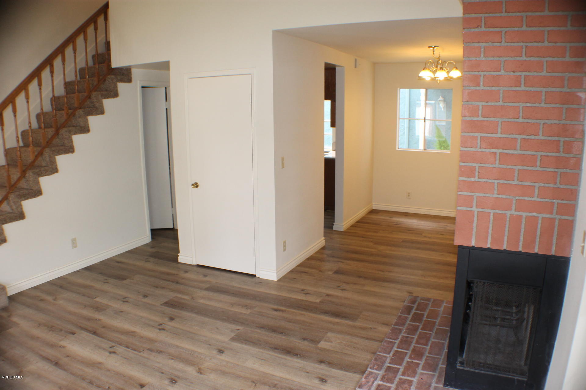 1878 Rory Lane, Unit 2 Simi Valley, CA 93063 - Photo 5 of 30 a view of a hallway with wooden floor and staircase