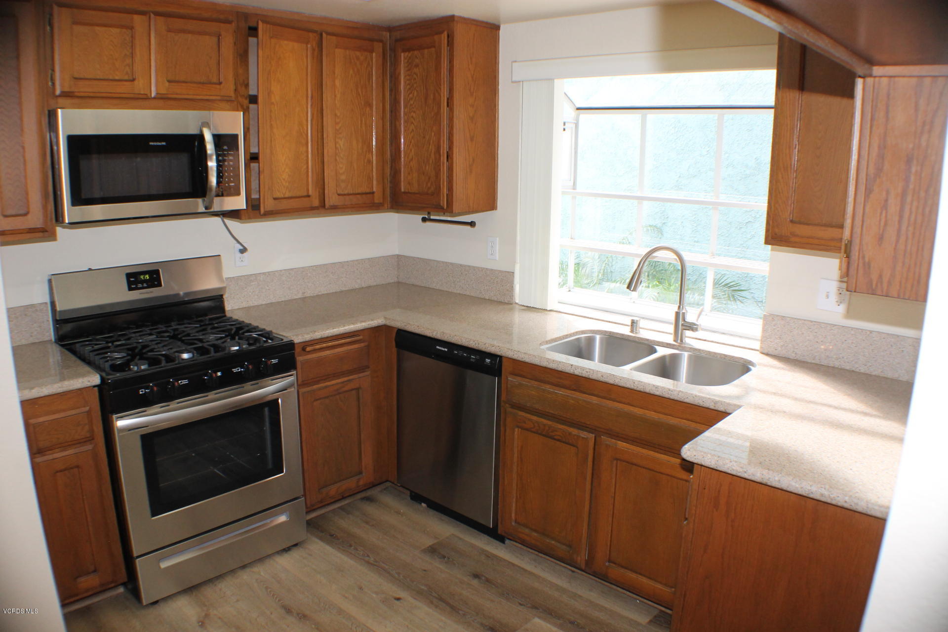1878 Rory Lane, Unit 2 Simi Valley, CA 93063 - Photo 9 of 30 a kitchen with stainless steel appliances a stove a sink a microwave and cabinets