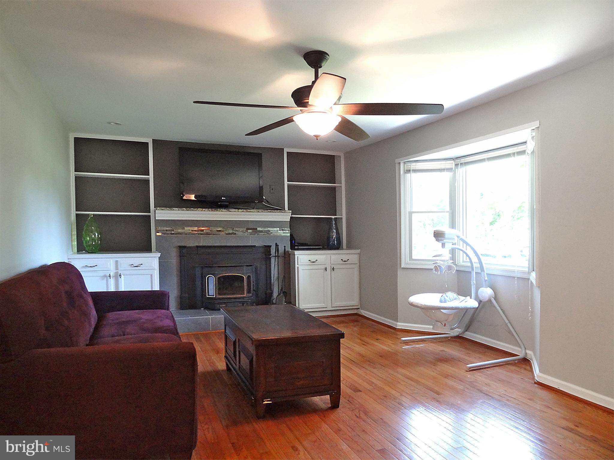 895 Woods Road Pasadena, MD 21122 - Photo 12 of 27 HARDWOODS IN THE LIVING ROOM WITH BAY WINDOW