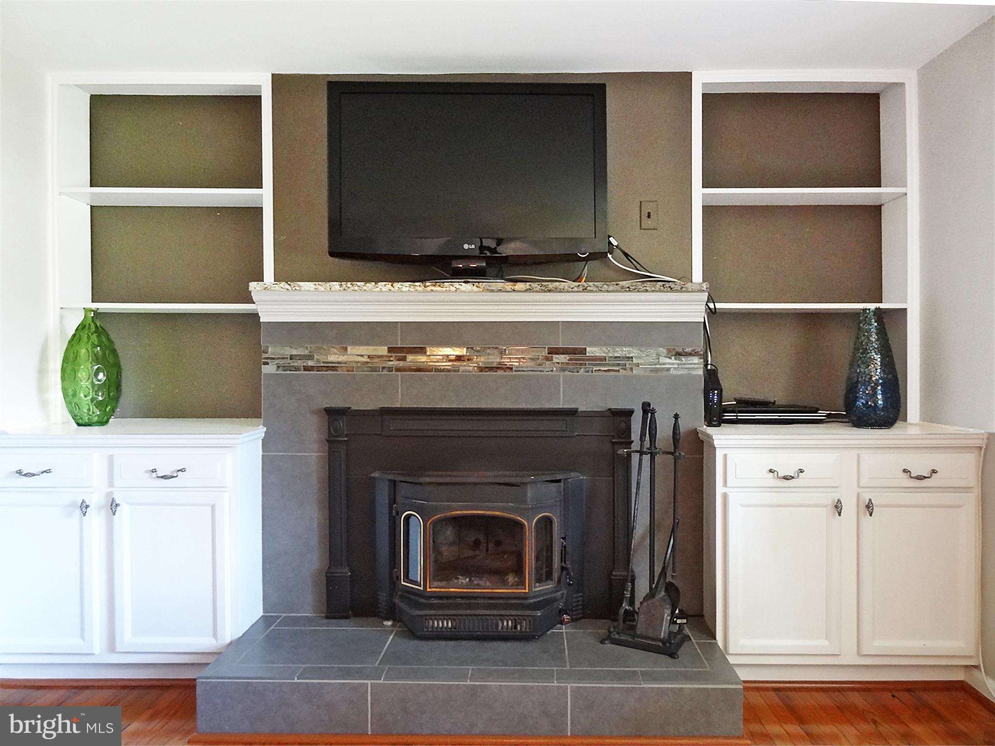 895 Woods Road Pasadena, MD 21122 - Photo 13 of 27 BUILT-IN BOOKSHELVES AND QUADRA-FIRE WOOD STOVE