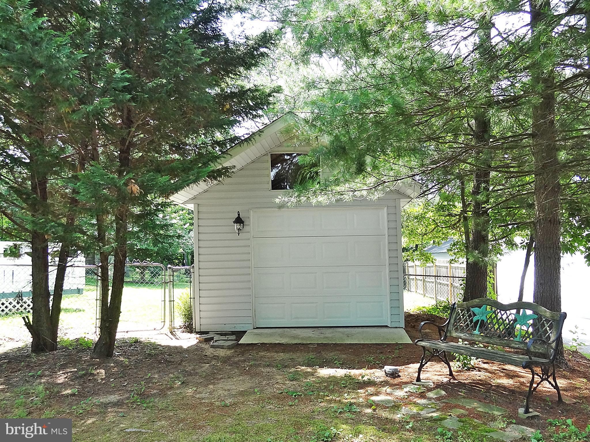 895 Woods Road Pasadena, MD 21122 - Photo 24 of 27 SHED WITH POWER AND GARAGE DOOR