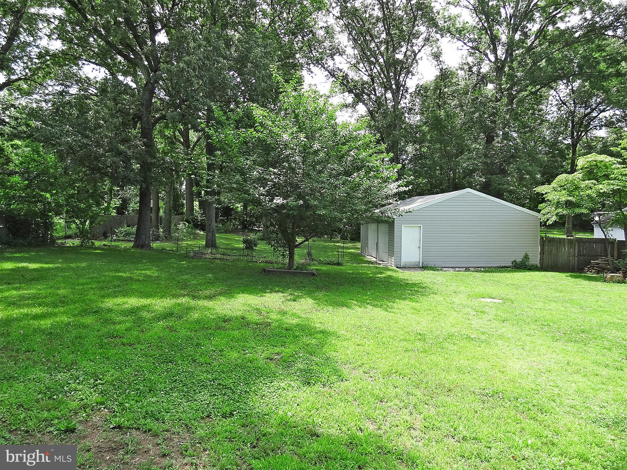 895 Woods Road Pasadena, MD 21122 - Photo 5 of 27 YARD CONTINUES PAST GARAGE A GOOD WAYS