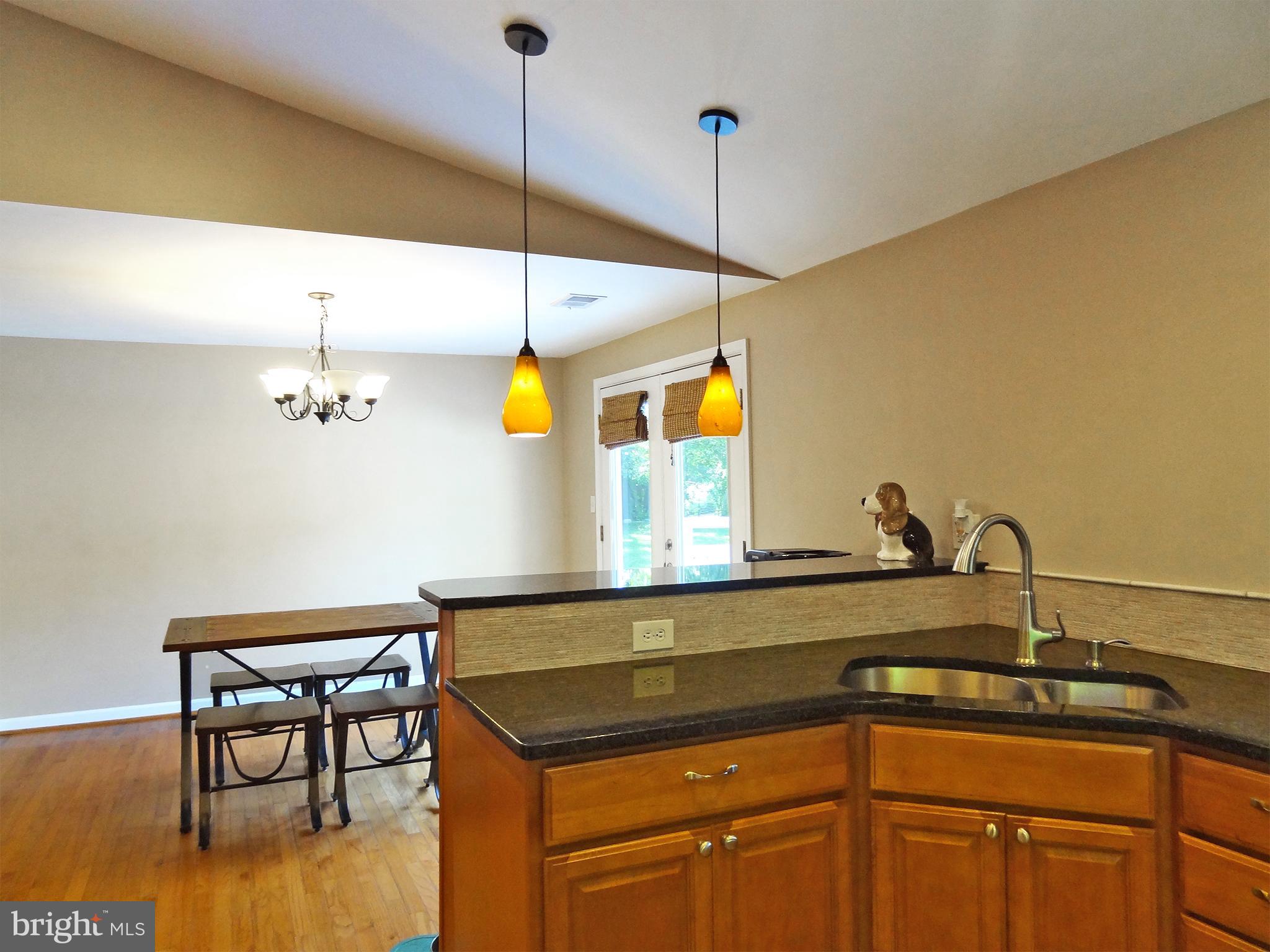 895 Woods Road Pasadena, MD 21122 - Photo 10 of 27 KITCHEN OPENS TO DINING ROOM AND DECK TO BACKYARD