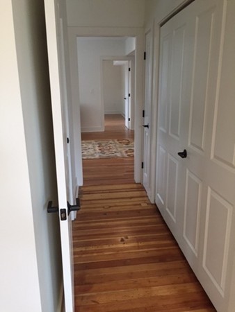 89 Main Street, Unit 12 Andover, MA 01810 - Photo 7 of 11 a view of a hallway with wooden floor and staircase