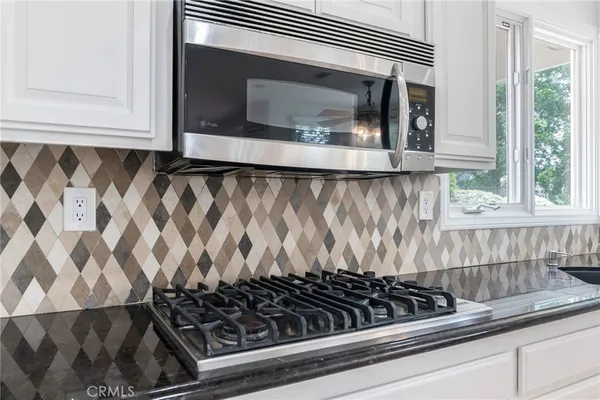 a close view of a stove a microwave oven and a cabinets