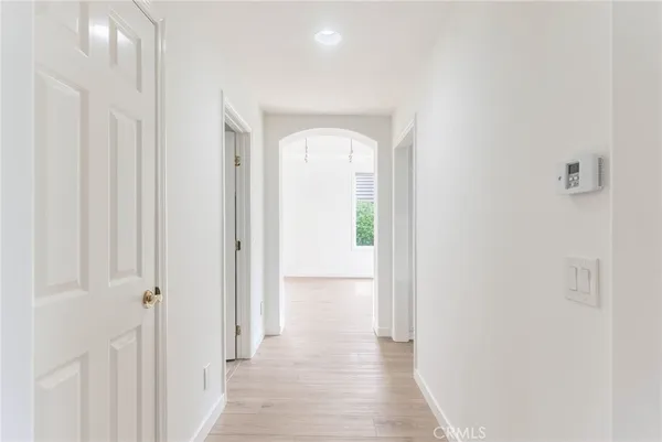 a view of a hallway with wooden floor
