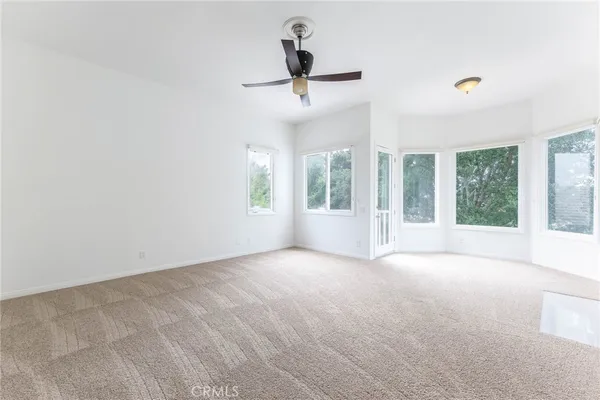 a view of a livingroom with a ceiling fan and window