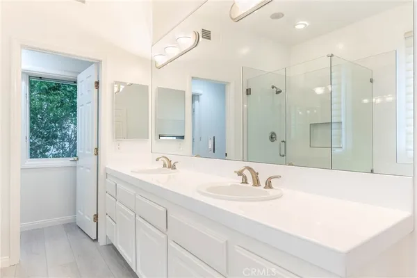 a bathroom with a sink double vanity and a mirror