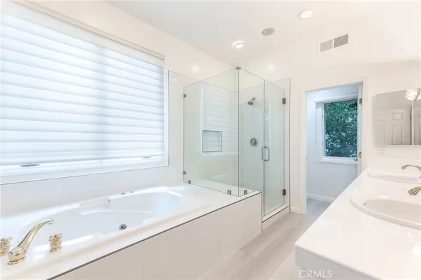 a bathroom with a tub sink and a shower