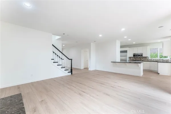 a view of a kitchen with a sink and a refrigerator