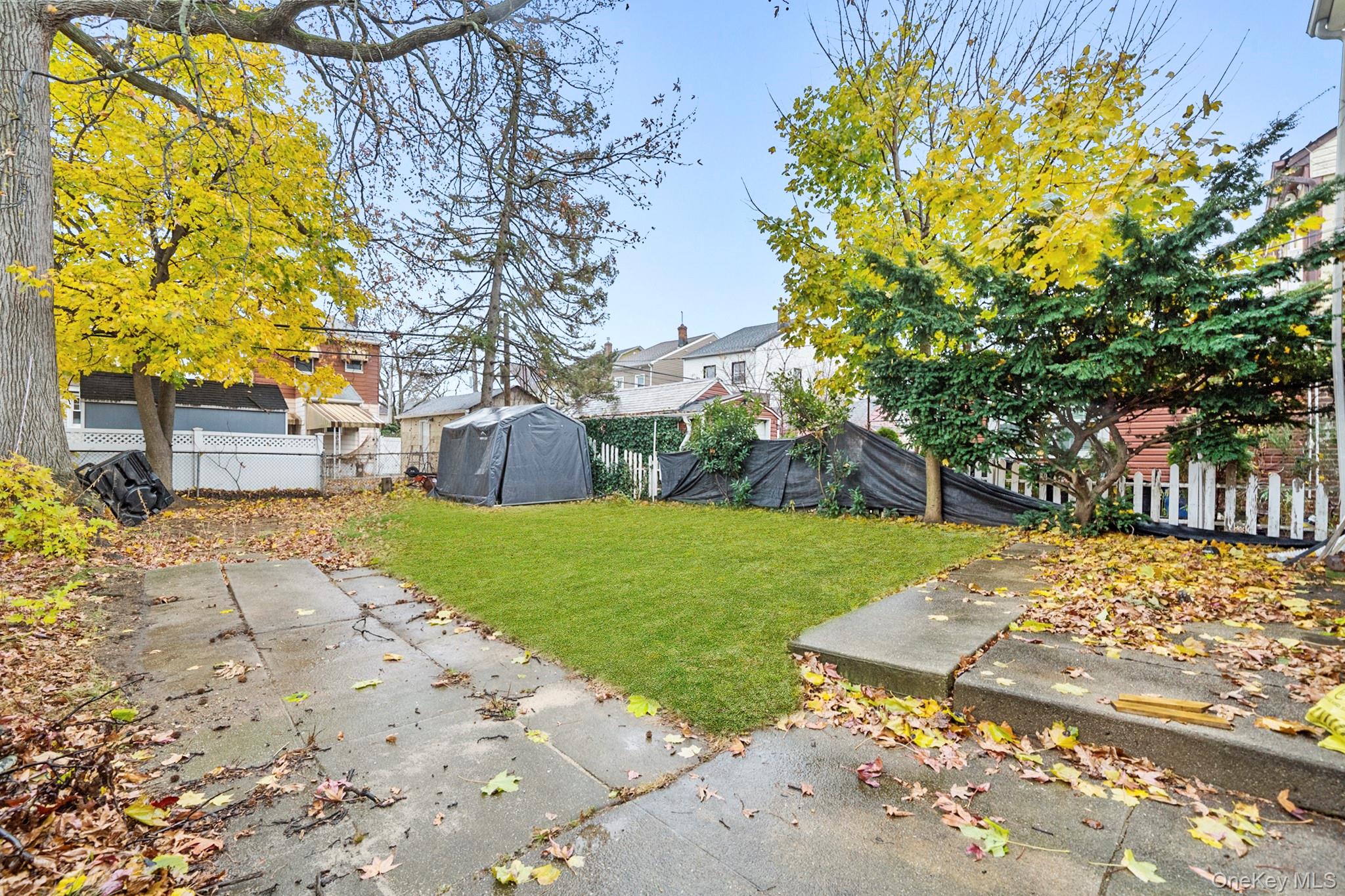 86-33 253rd Street Queens, NY 11426 - Photo 11 of 17 a view of a yard with plants and trees