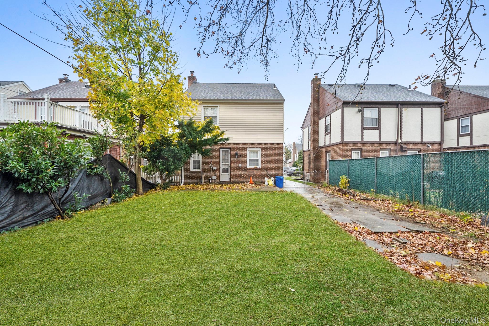 86-33 253rd Street Queens, NY 11426 - Photo 12 of 17 a front view of a house with garden