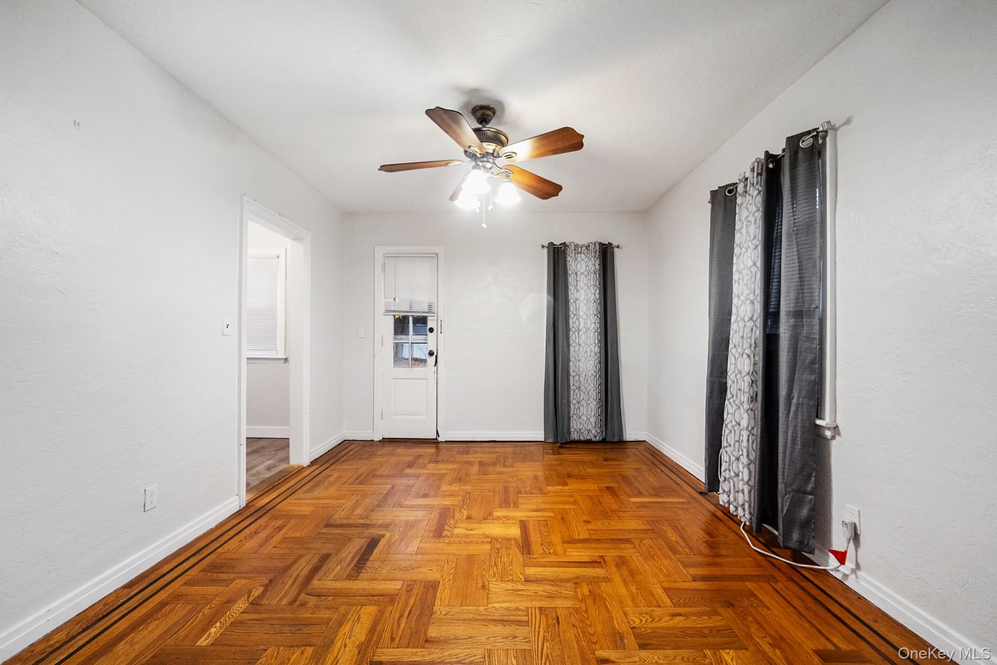 86-33 253rd Street Queens, NY 11426 - Photo 4 of 17 a bedroom with a bed and a chandelier