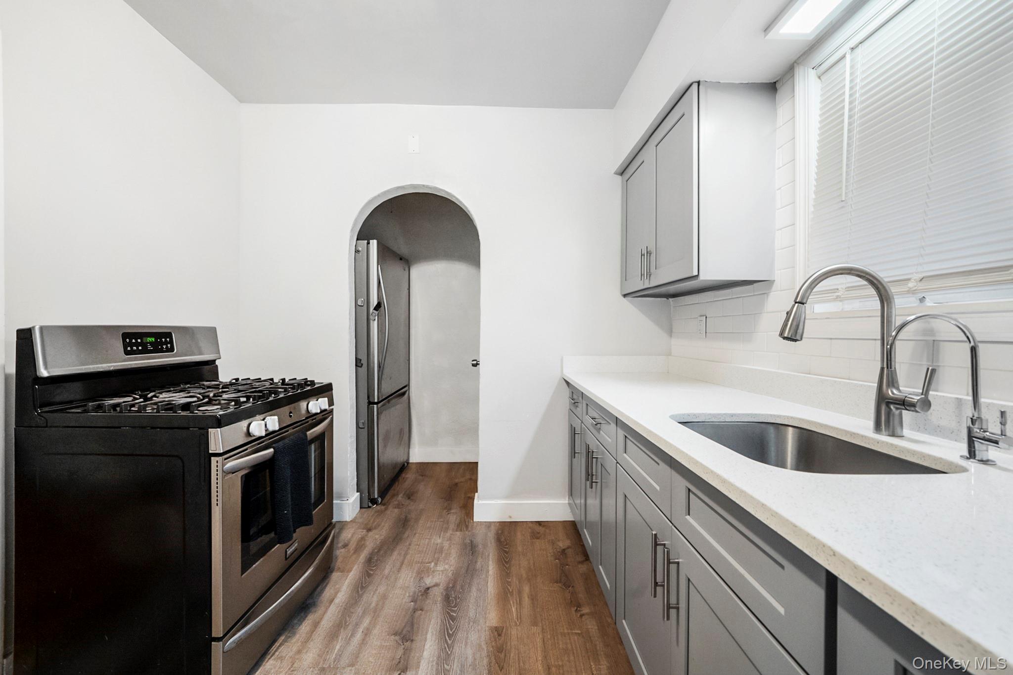 86-33 253rd Street Queens, NY 11426 - Photo 5 of 17 a kitchen with sink a stove and refrigerator