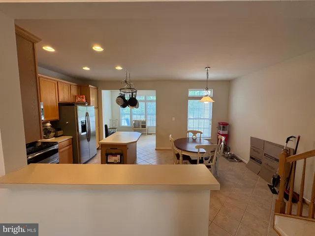 a view of a kitchen with an empty space and a window