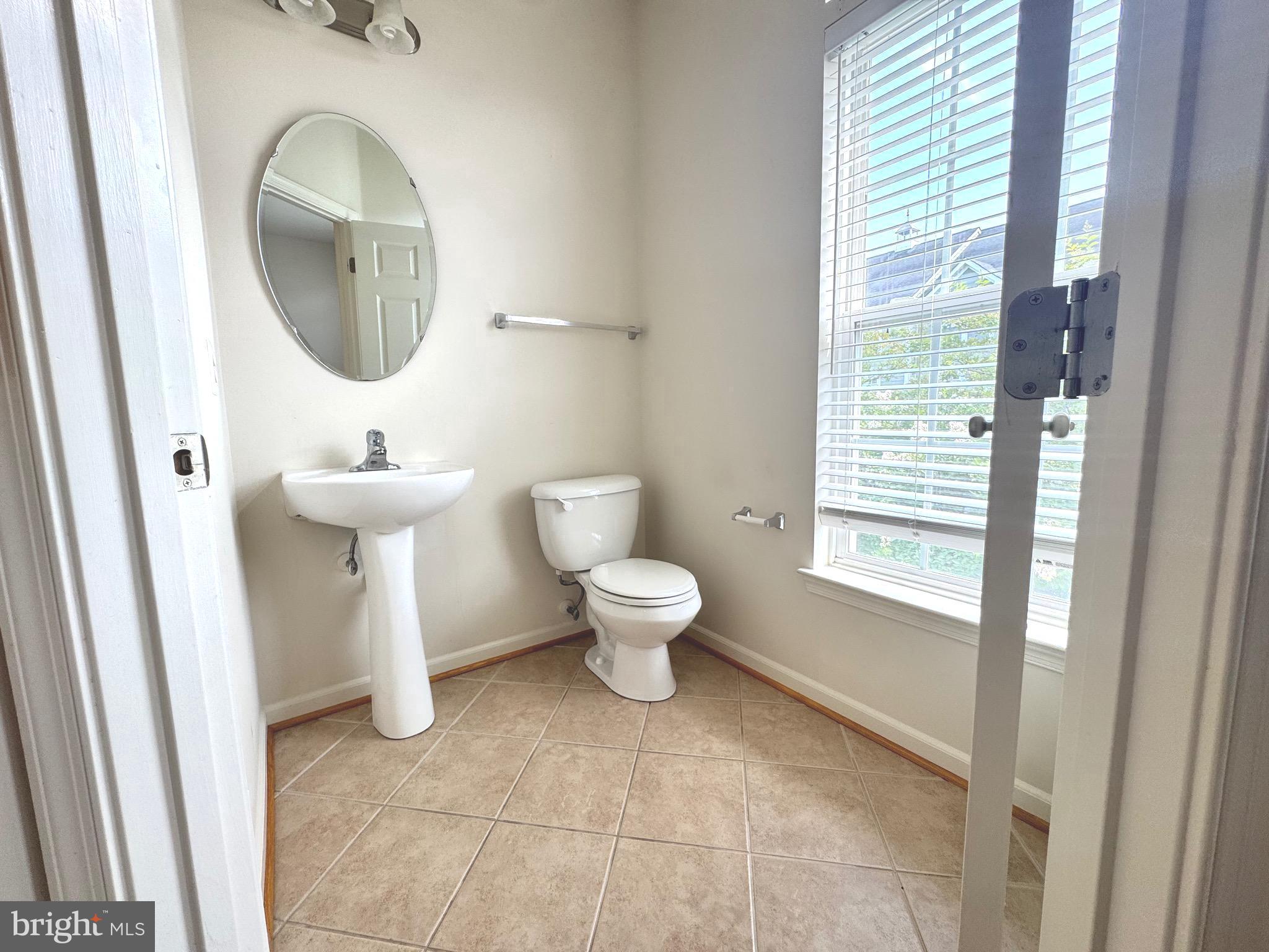 309 Monroe Point Drive Colonial Beach, VA 22443 - Photo 20 of 52 a bathroom with a toilet sink and mirror