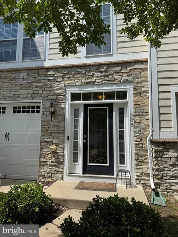 front view of a brick house with a large window