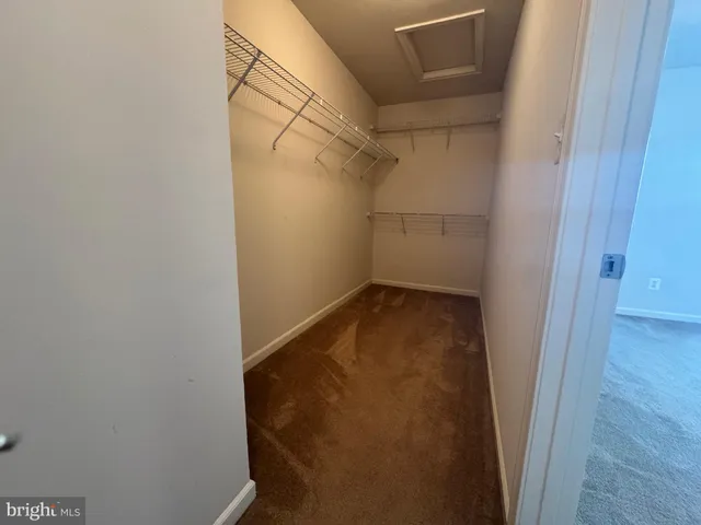 an empty room that has a grey walls