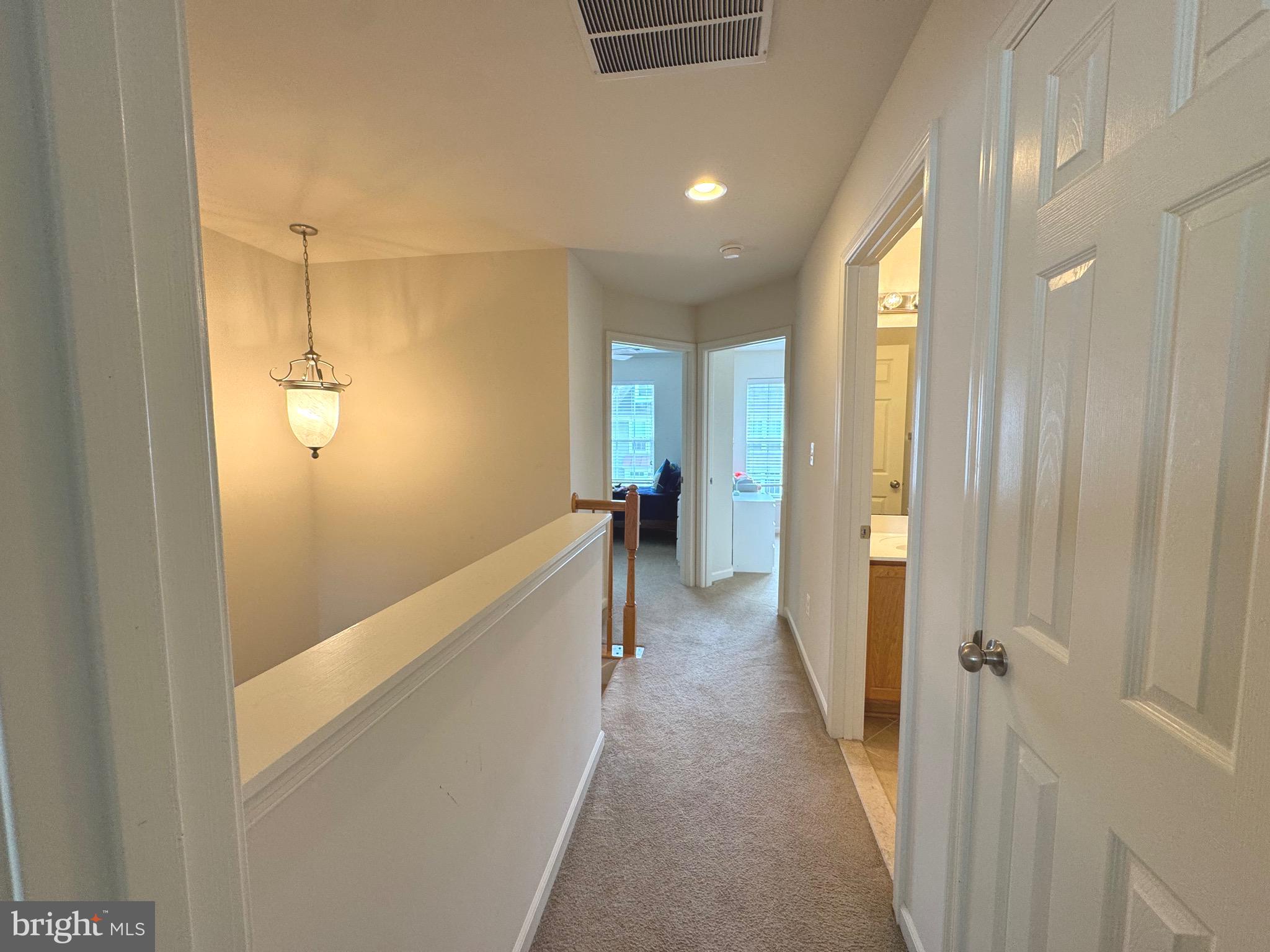 309 Monroe Point Drive Colonial Beach, VA 22443 - Photo 24 of 52 a view of a hallway with wooden floor and staircase