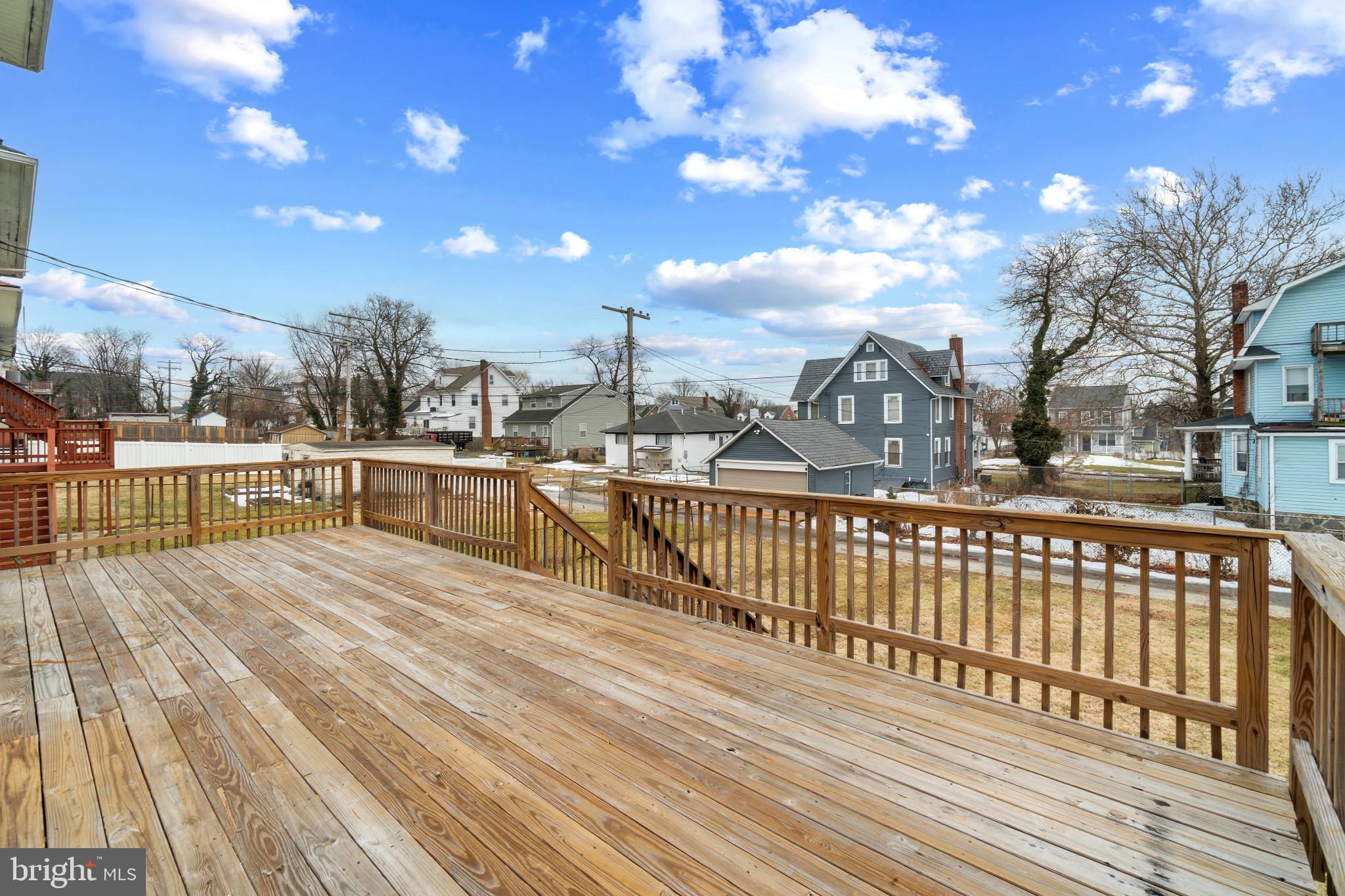 4021 Barrington Road Baltimore, MD 21207 - Photo 36 of 50 a view of a balcony with wooden floor and city view