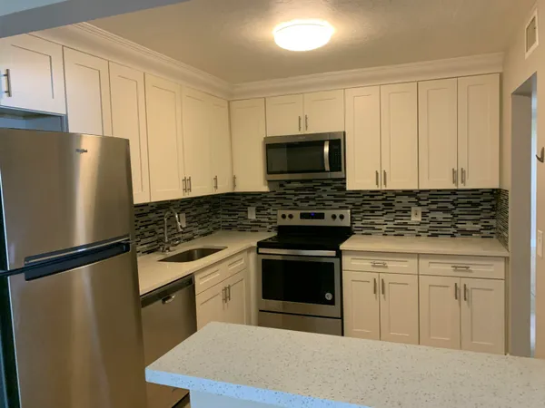 a kitchen with a refrigerator stove and microwave